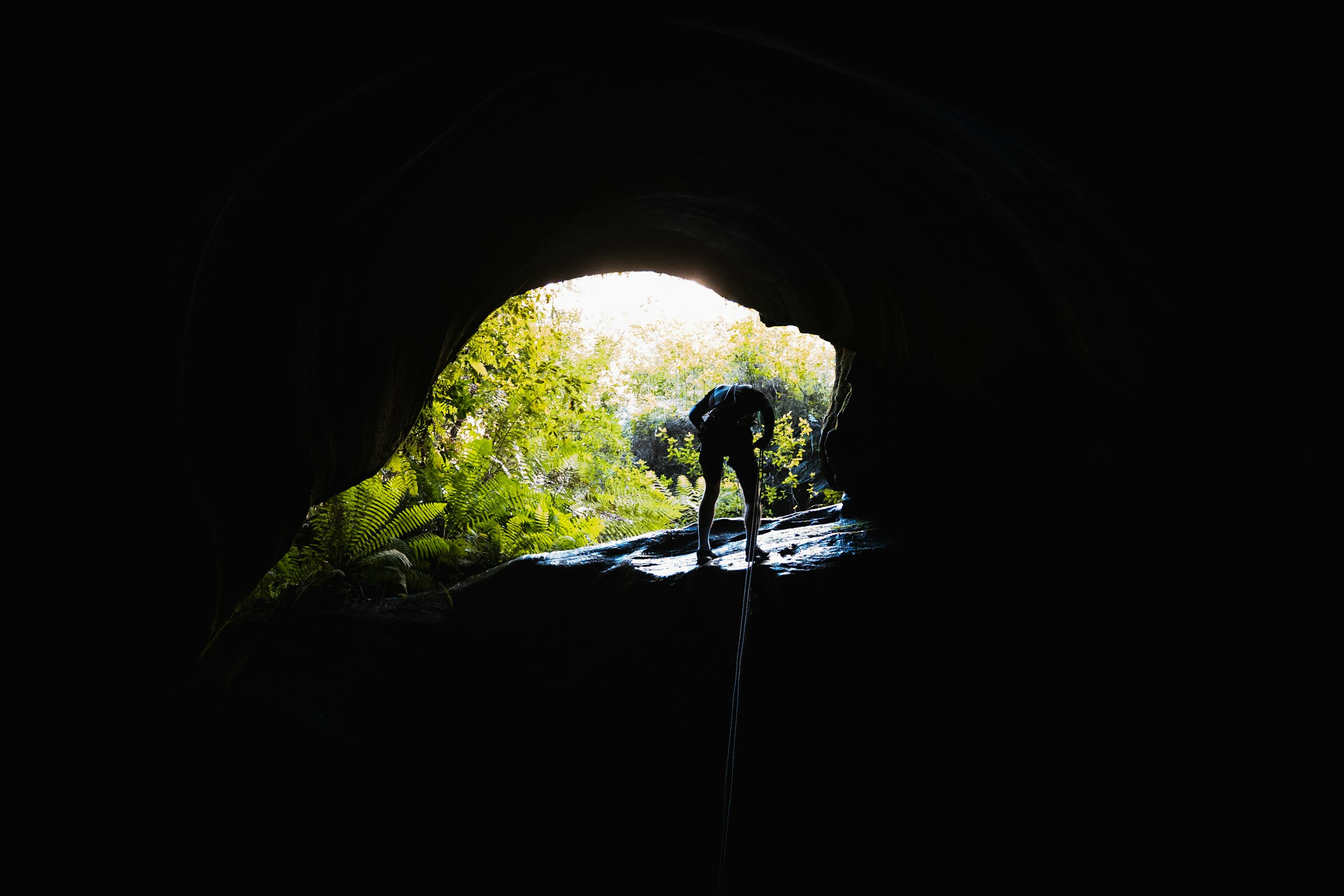 Rappelling out of a dark slot into daylight