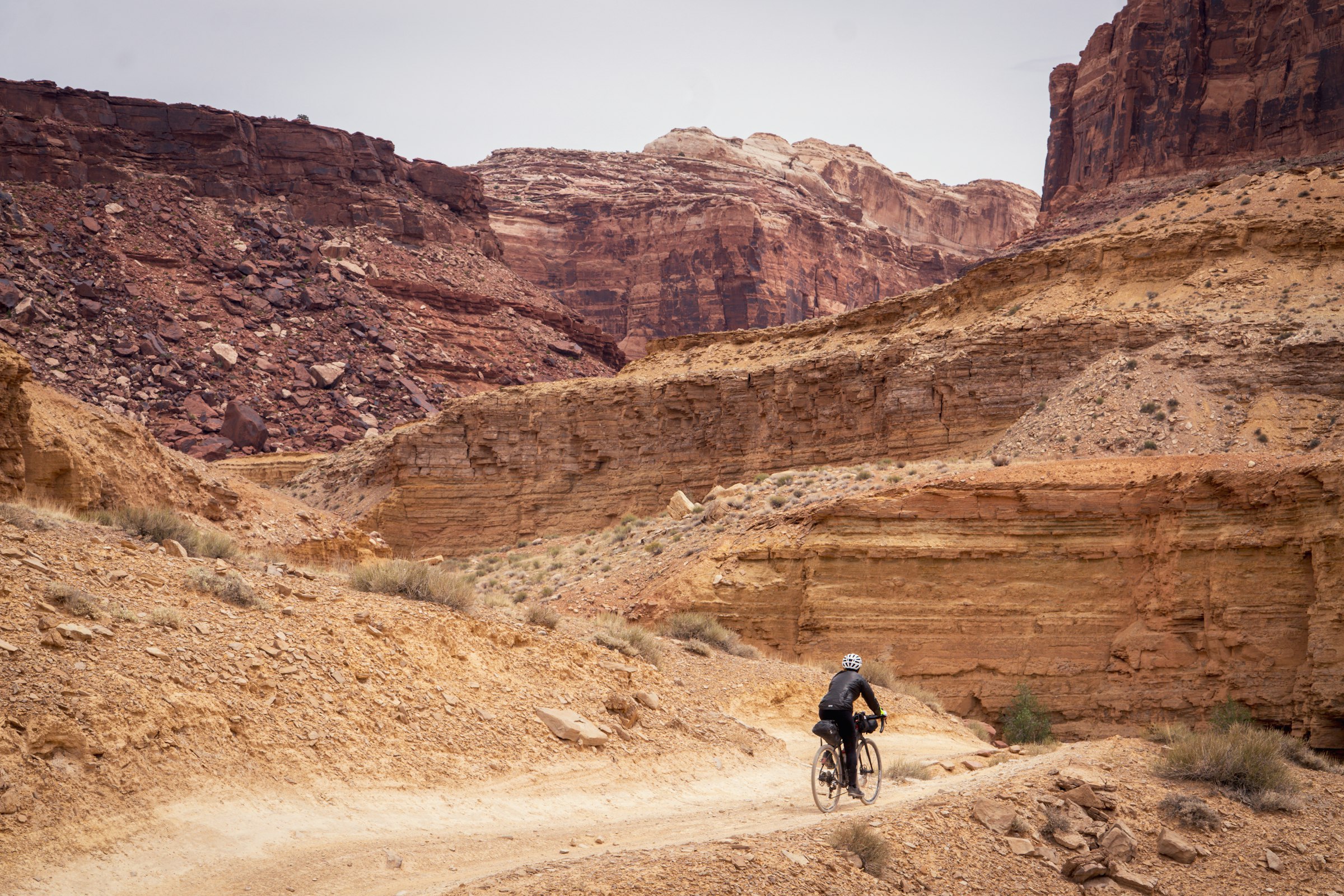A rider on the canyon section under red cliffs