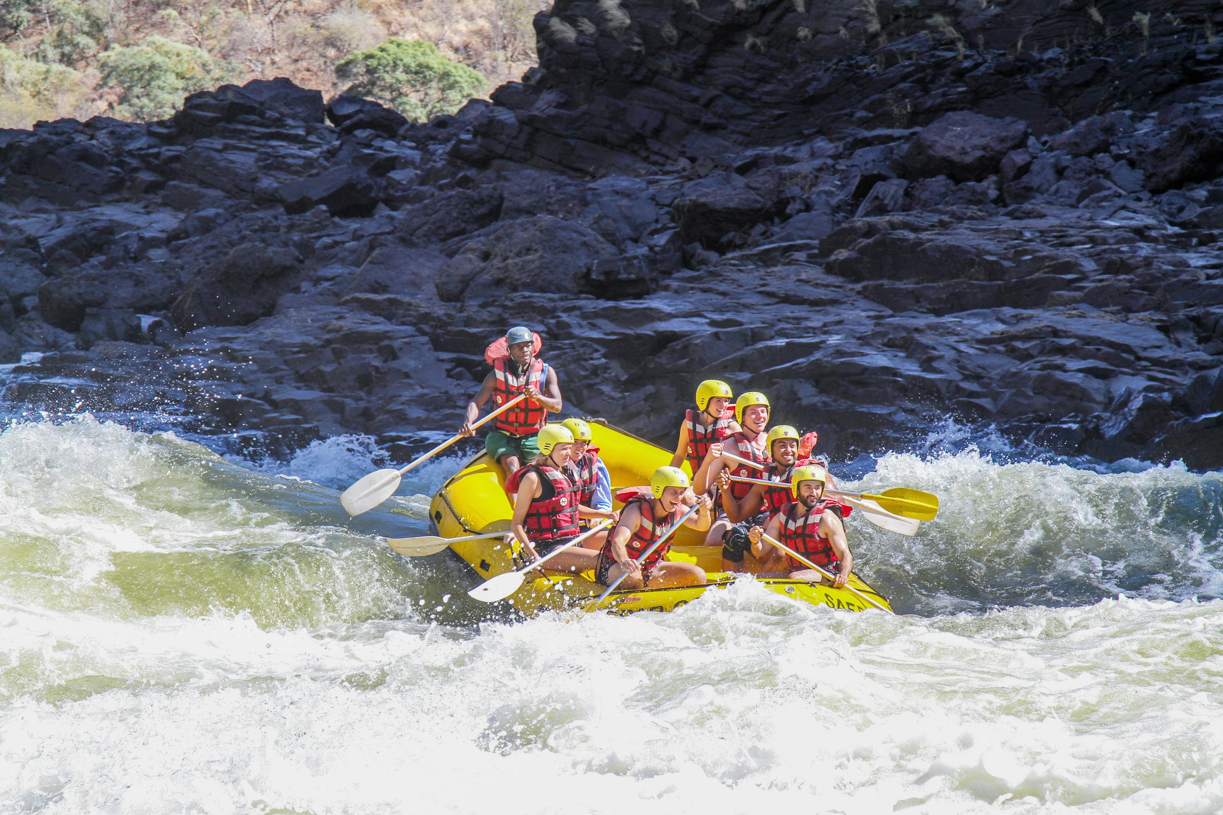A raft punching the big rapid in the canyon