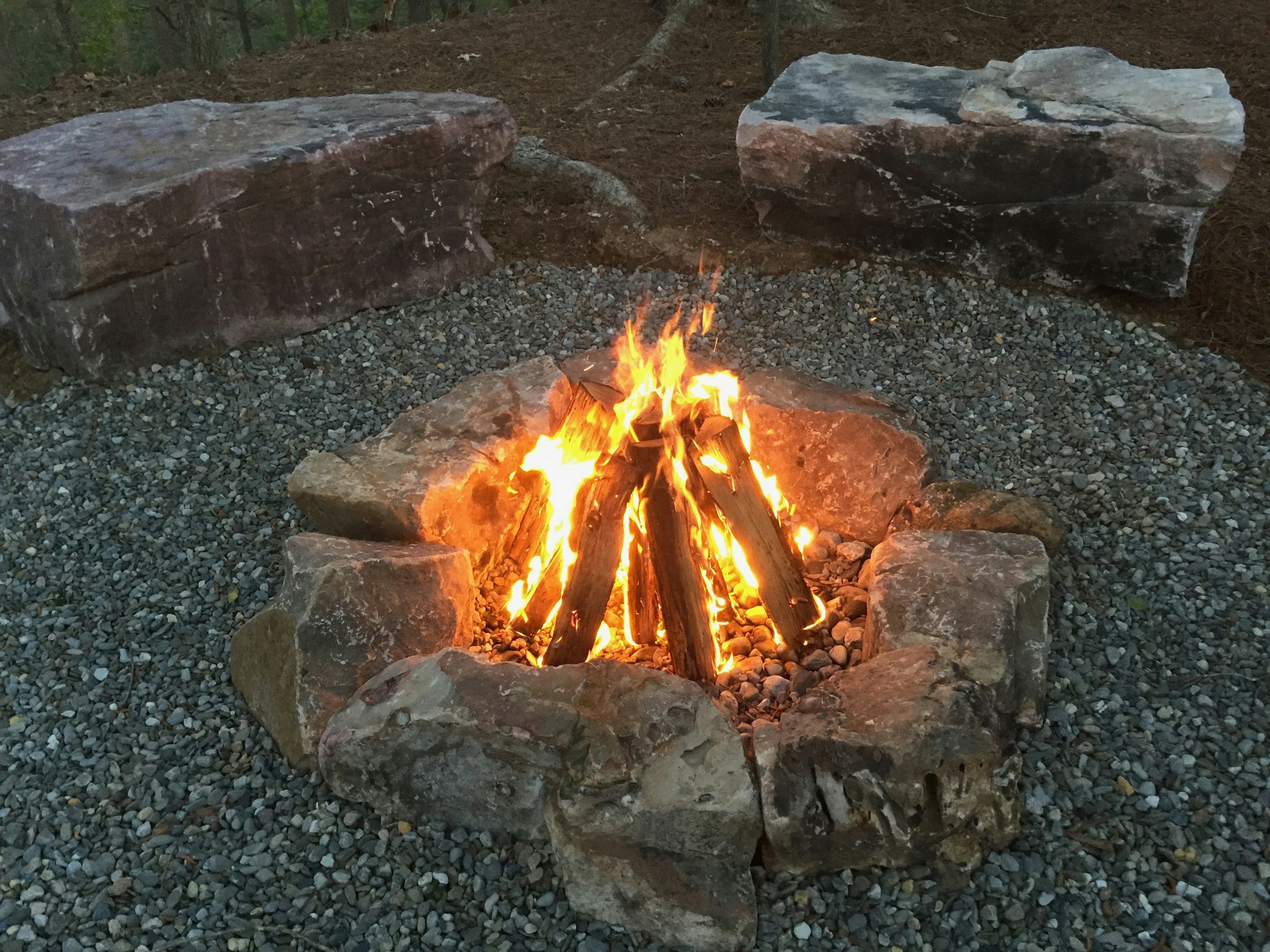 A stone fire ring on a river-loop site